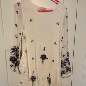 White dress with colorful details.